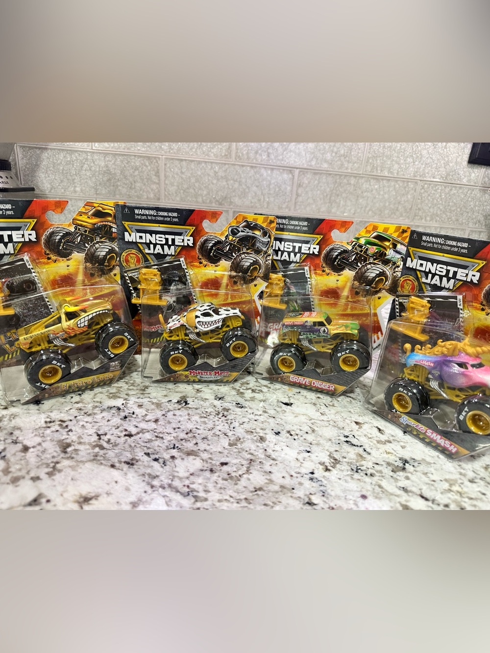Set of all four. Monster Jam 1:24 Gold Series Die-Cast Trucks.